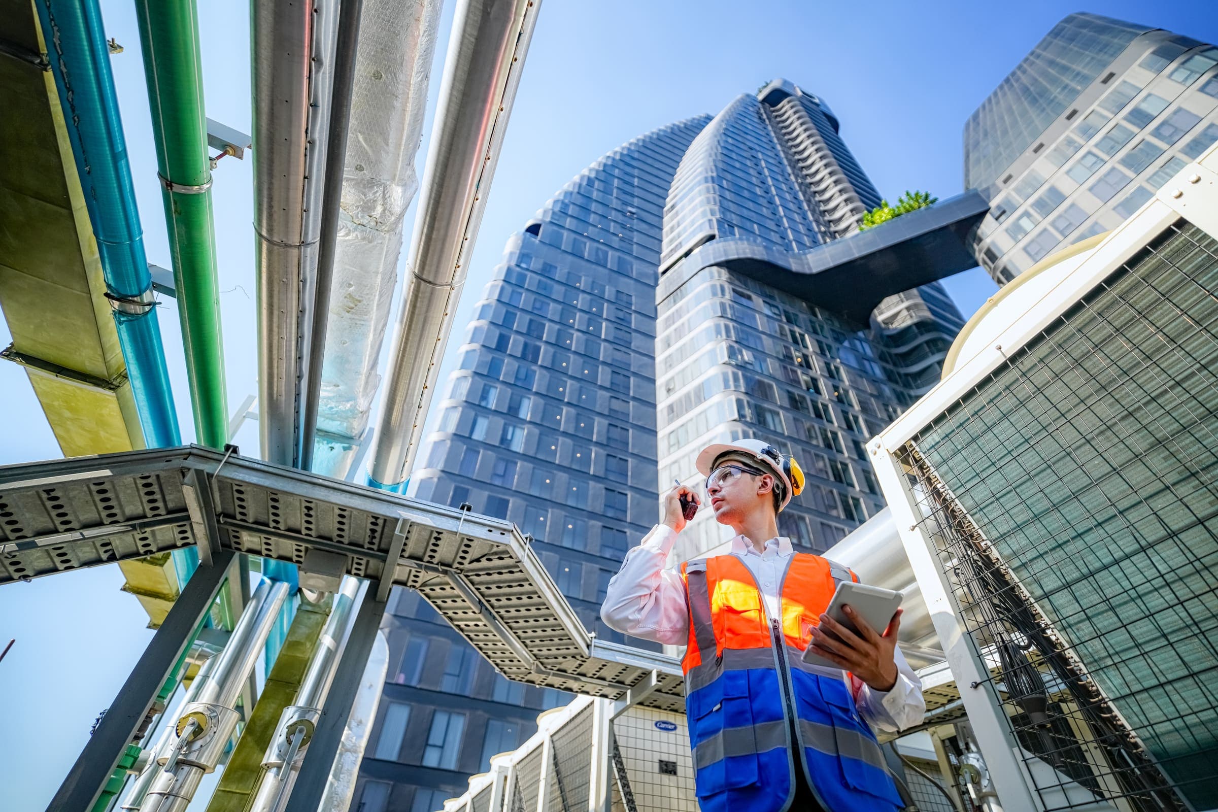 Building engineer inspecting a construction site from a city rooftop