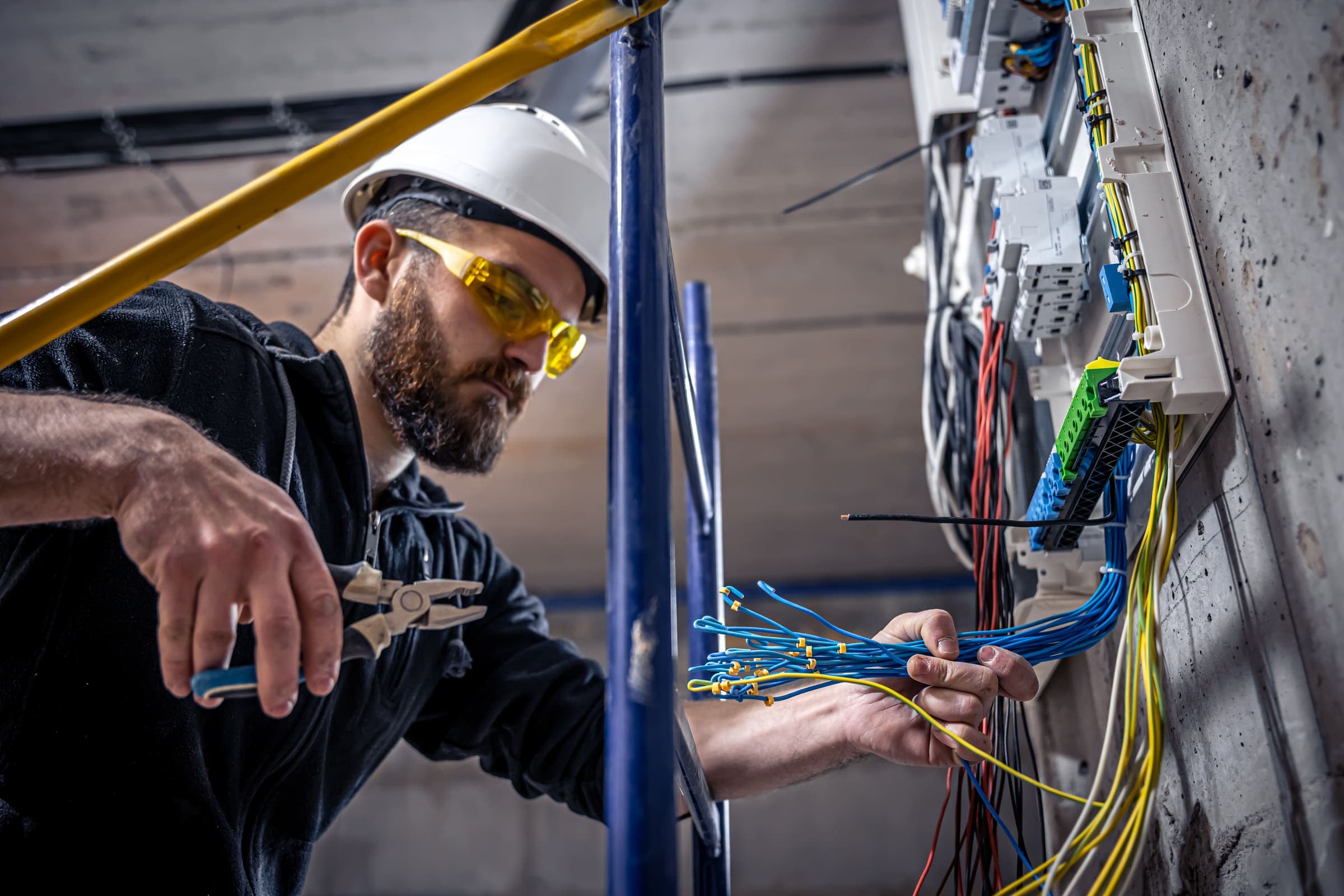 Electrician working with wiring inside a building under construction