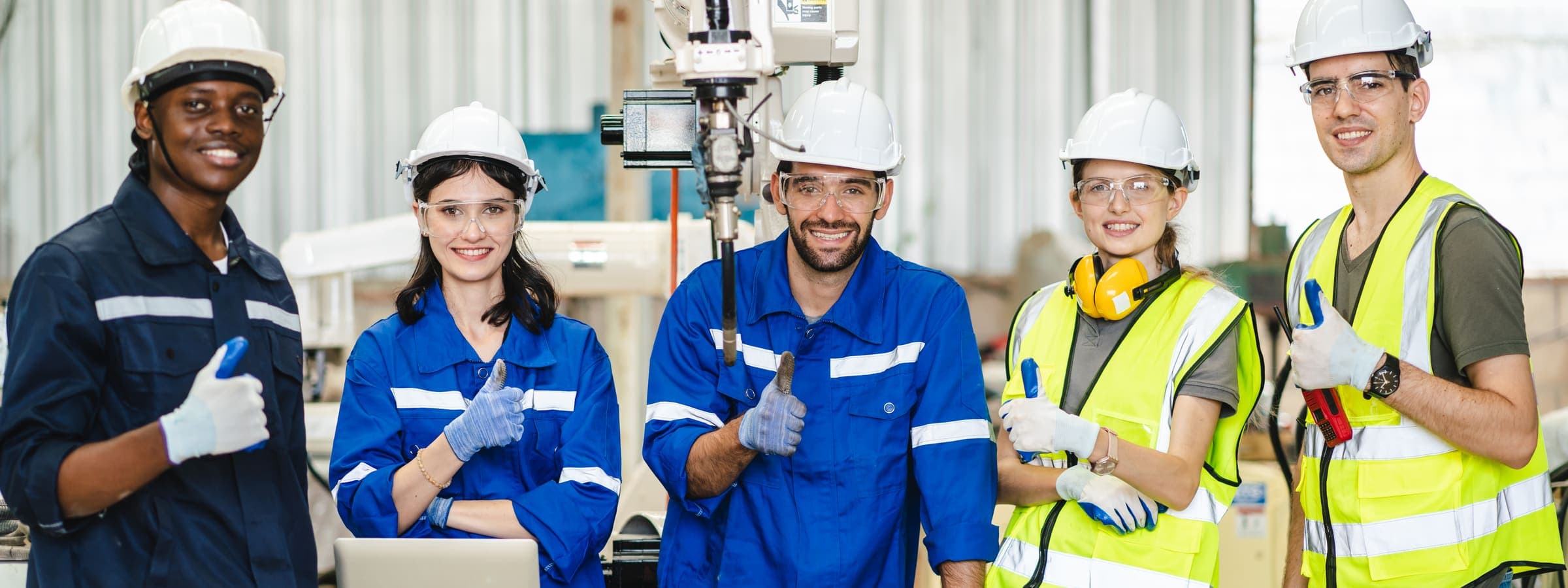 Confident team of engineers in a factory setting
