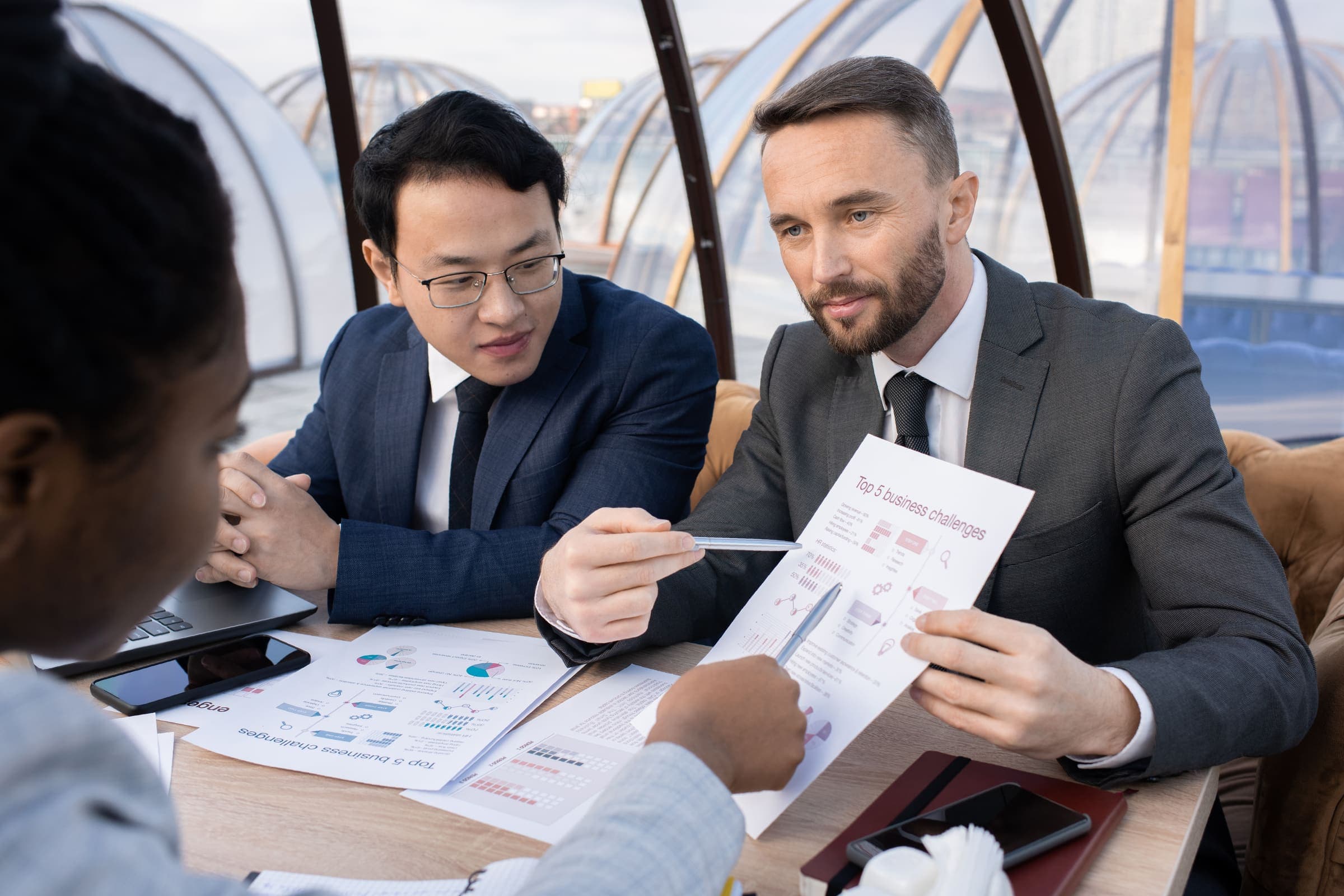 Business professionals discussing finance figures in an office